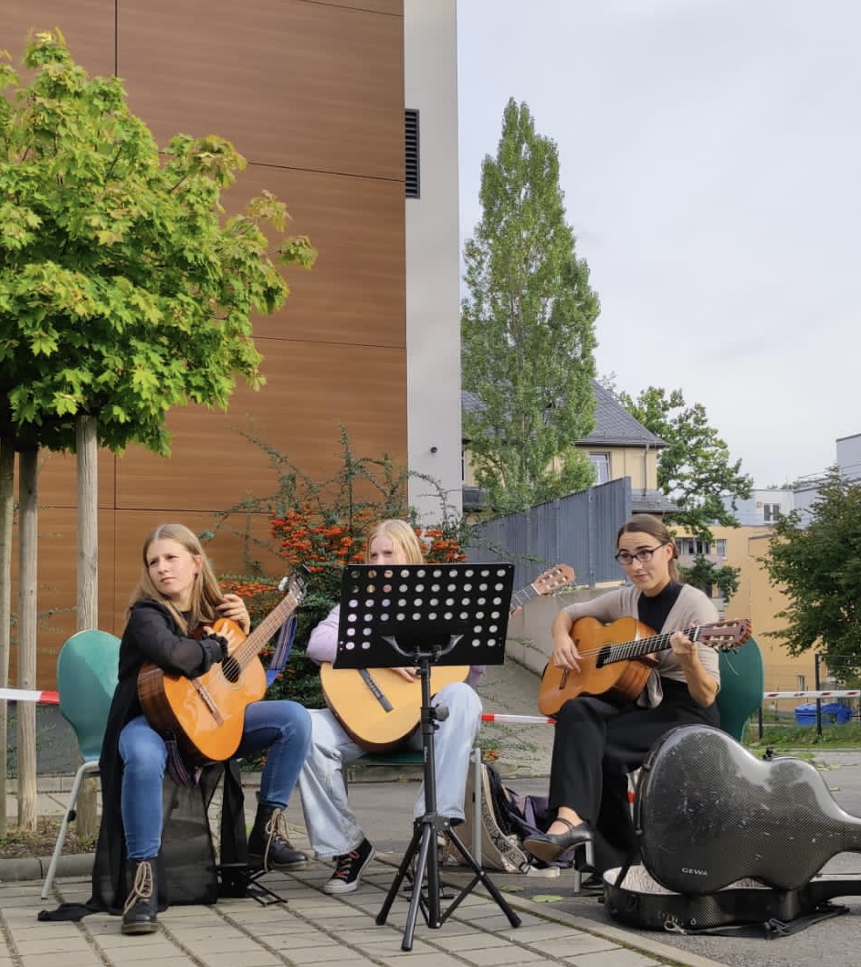Drei Gitarren begleiten die Musikalische Früherziehung bei ihrem Hofkonzert